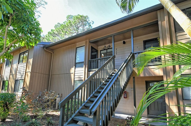 property entrance with covered porch and central AC unit