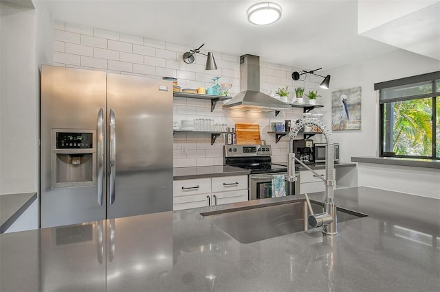 kitchen with exhaust hood, stainless steel appliances, sink, white cabinets, and tasteful backsplash