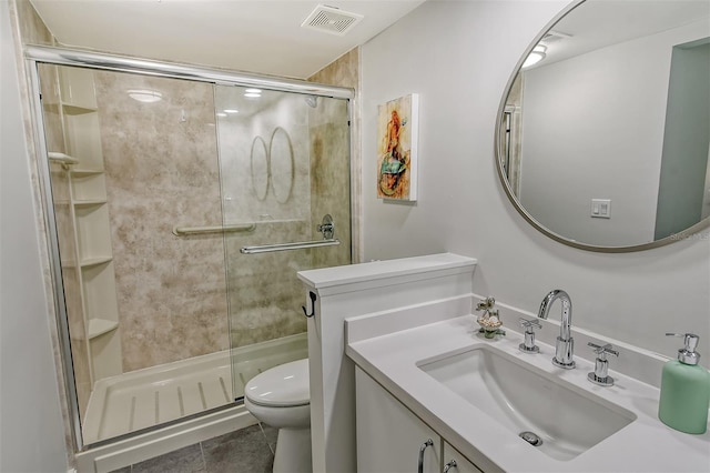 bathroom with vanity, a shower with shower door, toilet, and tile patterned floors