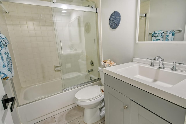 full bathroom featuring vanity, toilet, tile patterned floors, and shower / bath combination with glass door