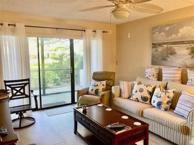 living room featuring a textured ceiling and ceiling fan