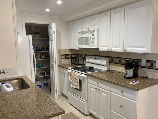 kitchen with ornamental molding, white cabinetry, backsplash, and white appliances