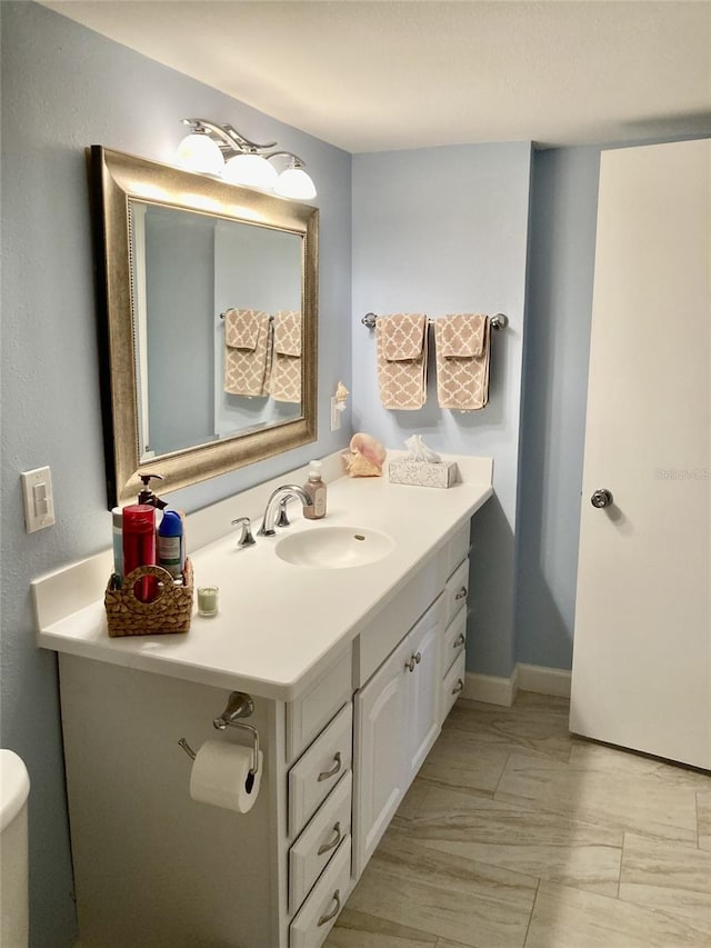 bathroom featuring vanity and toilet