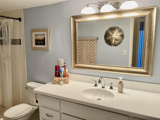 bathroom with vanity, toilet, and a shower with shower curtain