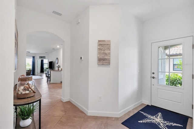 tiled entryway featuring a wealth of natural light