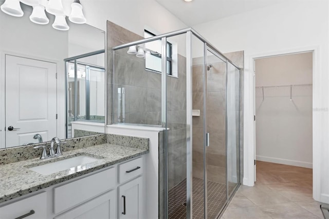 bathroom featuring vanity, tile patterned floors, and an enclosed shower