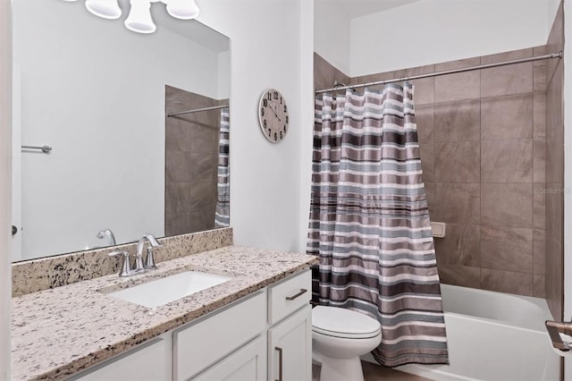 full bathroom with shower / tub combo with curtain, vanity, and toilet