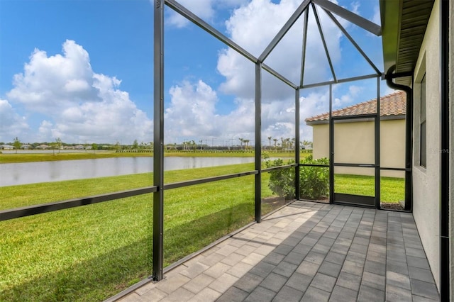 unfurnished sunroom featuring a water view