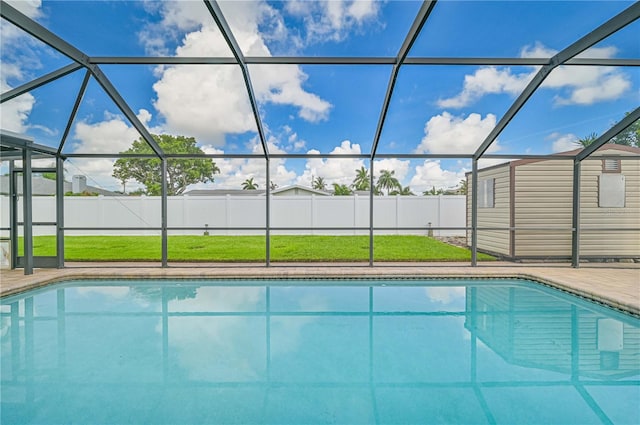 view of pool featuring a patio, a yard, and glass enclosure