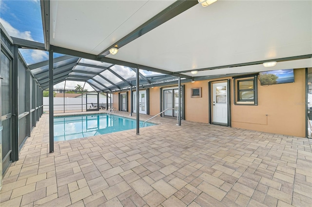 view of pool featuring a water view, a patio area, and a lanai