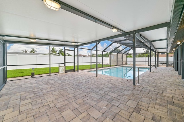 view of pool with a yard, a shed, a lanai, and a patio area