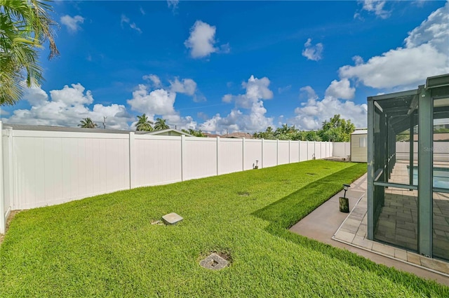 view of yard with glass enclosure