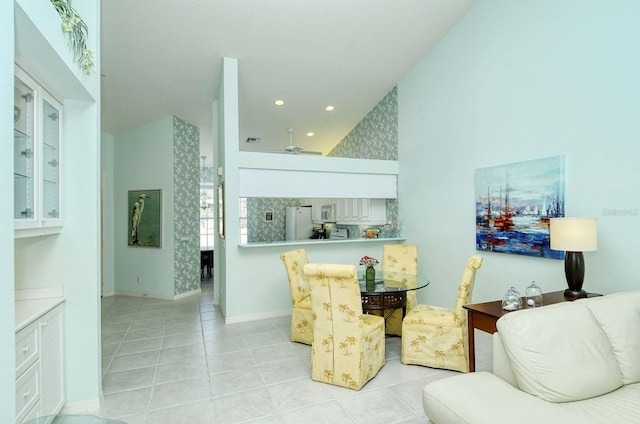 living room with a towering ceiling and light tile patterned floors