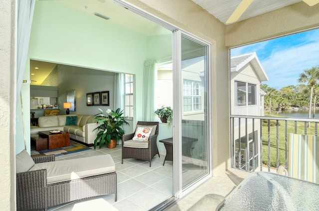 sunroom / solarium featuring a water view