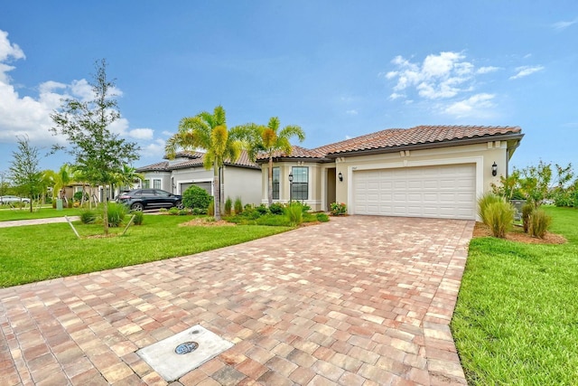 mediterranean / spanish house with a front yard and a garage