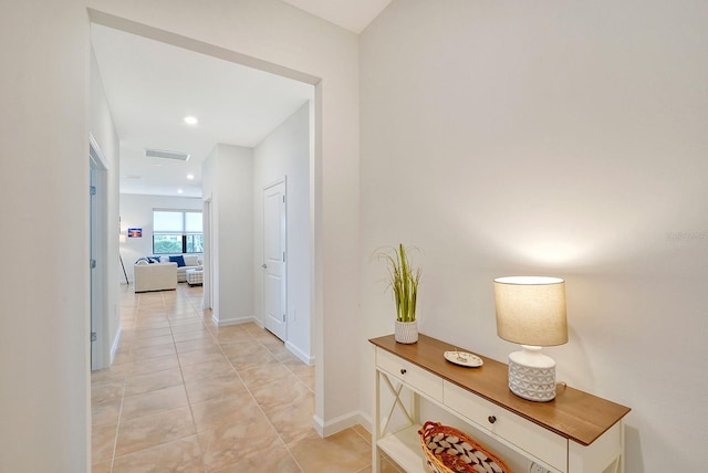 hall featuring light tile patterned floors