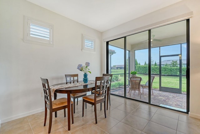 tiled dining space with ceiling fan