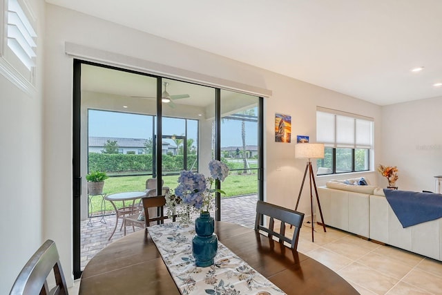 tiled dining room featuring ceiling fan and a healthy amount of sunlight