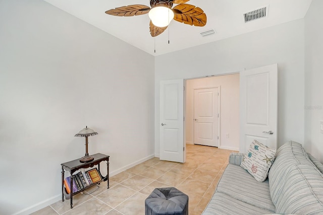 living room with light tile patterned floors and ceiling fan