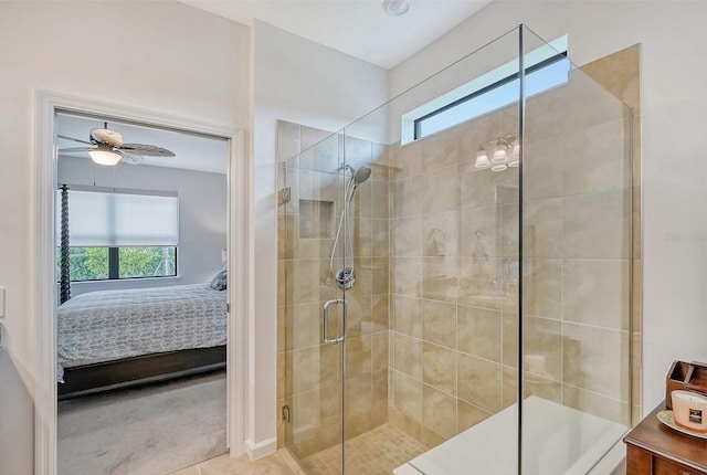 bathroom with tile patterned floors, ceiling fan, a healthy amount of sunlight, and a shower with shower door