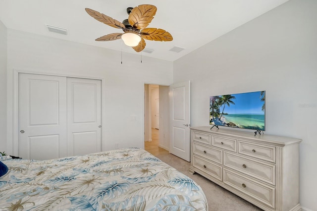 carpeted bedroom with ceiling fan and a closet