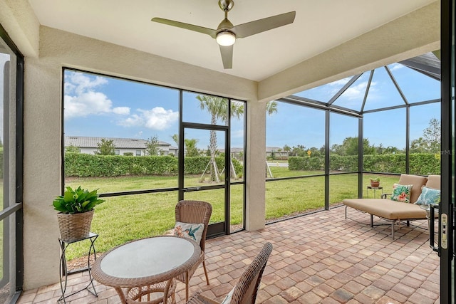 sunroom featuring ceiling fan