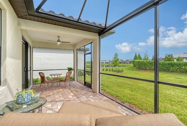 unfurnished sunroom with ceiling fan