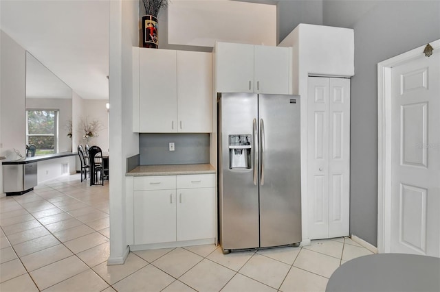 kitchen with white cabinetry, stainless steel refrigerator with ice dispenser, and light tile patterned flooring