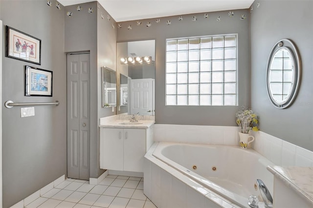 bathroom featuring a relaxing tiled tub, tile patterned flooring, and vanity