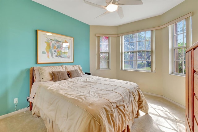 bedroom with ceiling fan and light colored carpet