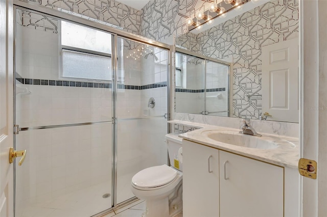 bathroom with vanity, toilet, and an enclosed shower