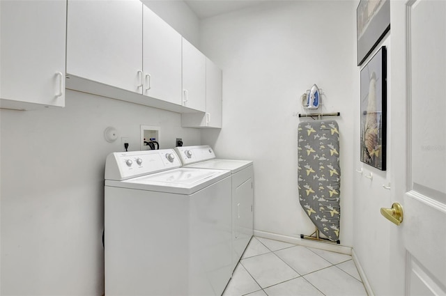 washroom with light tile patterned flooring, cabinets, and separate washer and dryer