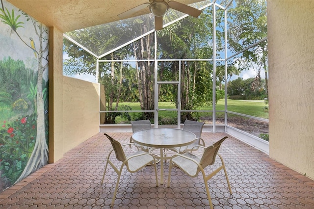 sunroom / solarium featuring ceiling fan