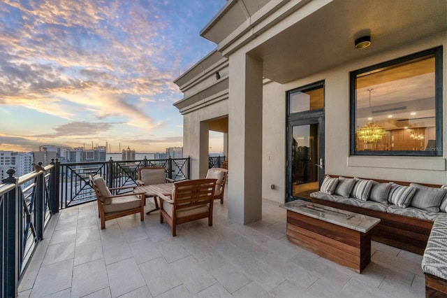 balcony at dusk with an outdoor hangout area