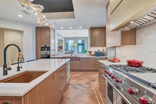 kitchen with designer range, sink, decorative light fixtures, and custom exhaust hood