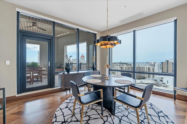 dining room with a chandelier and parquet flooring