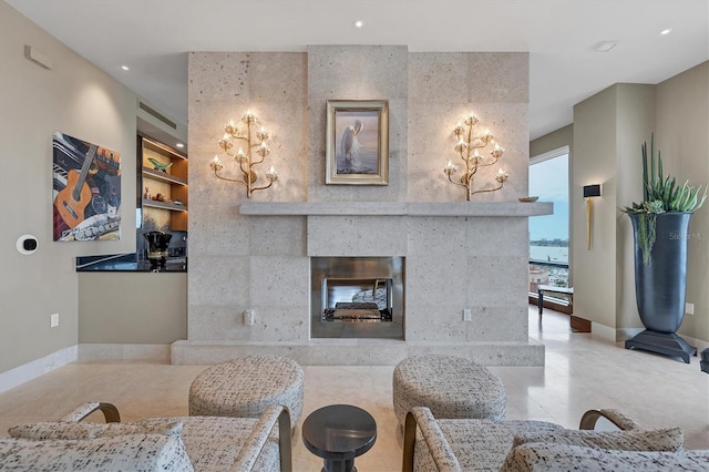 living room featuring a multi sided fireplace and a water view