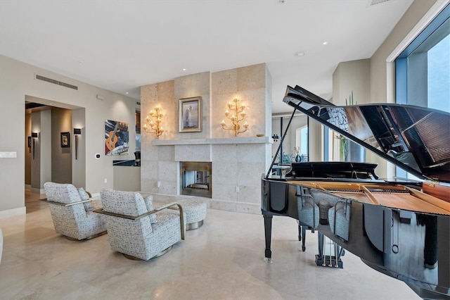 living area featuring elevator, plenty of natural light, and a tiled fireplace