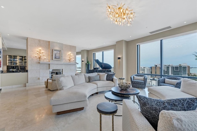 living room with a large fireplace and an inviting chandelier