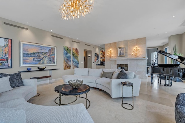 living room featuring a tile fireplace and an inviting chandelier