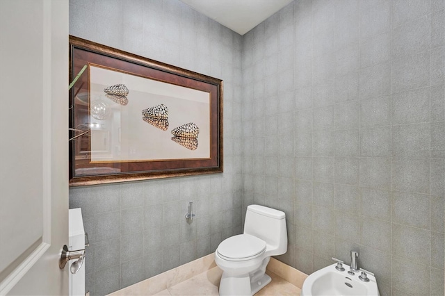 bathroom featuring tile patterned floors, a bidet, and toilet