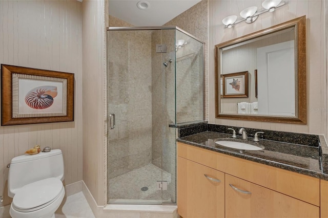 bathroom with tile patterned flooring, vanity, toilet, and a shower with door