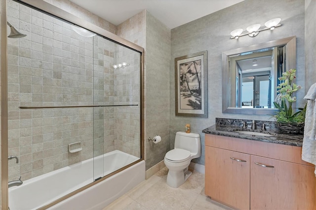 full bathroom featuring tile patterned floors, vanity, combined bath / shower with glass door, and toilet