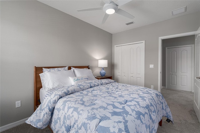 bedroom featuring visible vents, a closet, baseboards, ceiling fan, and carpet