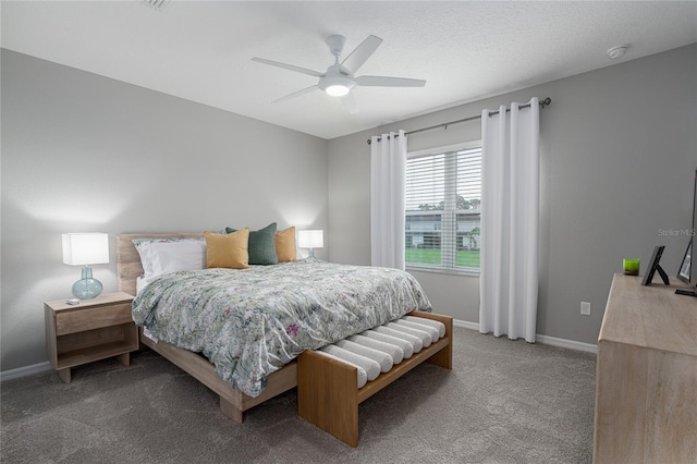 carpeted bedroom featuring a textured ceiling and ceiling fan