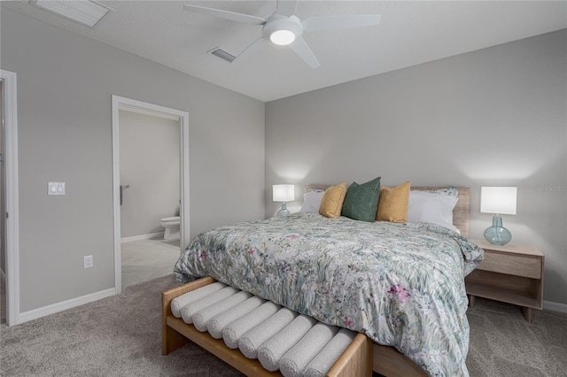 carpeted bedroom featuring baseboards, visible vents, ceiling fan, and ensuite bath