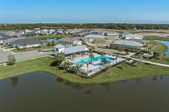 drone / aerial view featuring a residential view and a water view