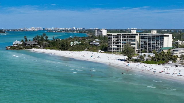 drone / aerial view featuring a beach view and a water view