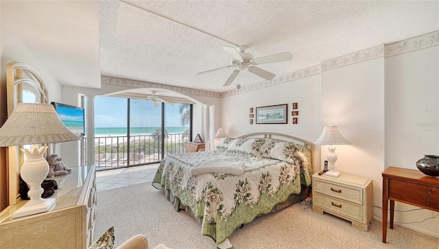 bedroom featuring light carpet, a textured ceiling, access to outside, and ceiling fan