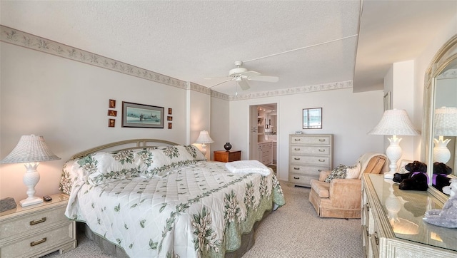 bedroom featuring ceiling fan, light colored carpet, a textured ceiling, and connected bathroom